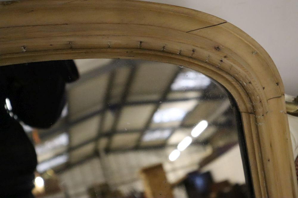 A late Victorian pine overmantel mirror, width 112cm height 65cm